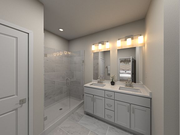 The primary bathroom offers dual vanity sinks and a walk-in closet.