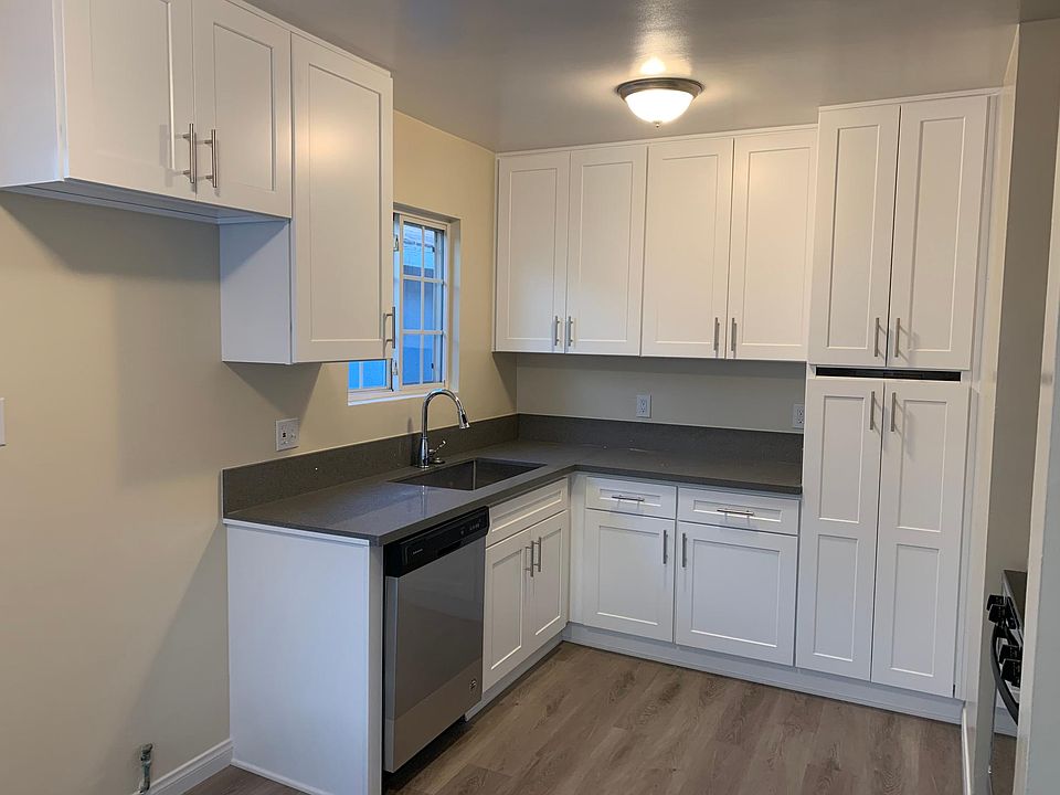 Quartz counter top on white shaker cabinets, new dishwasher.