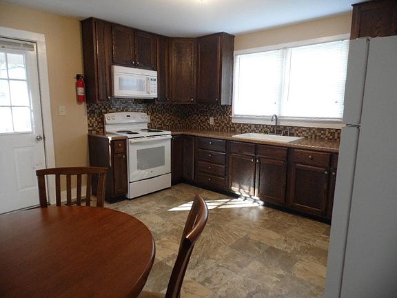 Kitchen view 1 (14' x 14') stove and microwave plus new refrigerator