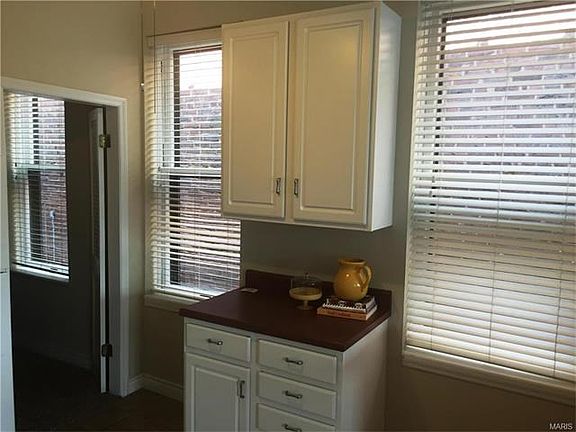 Additional counter and storage in Kitchen with 2 large windows for great natural lighting.