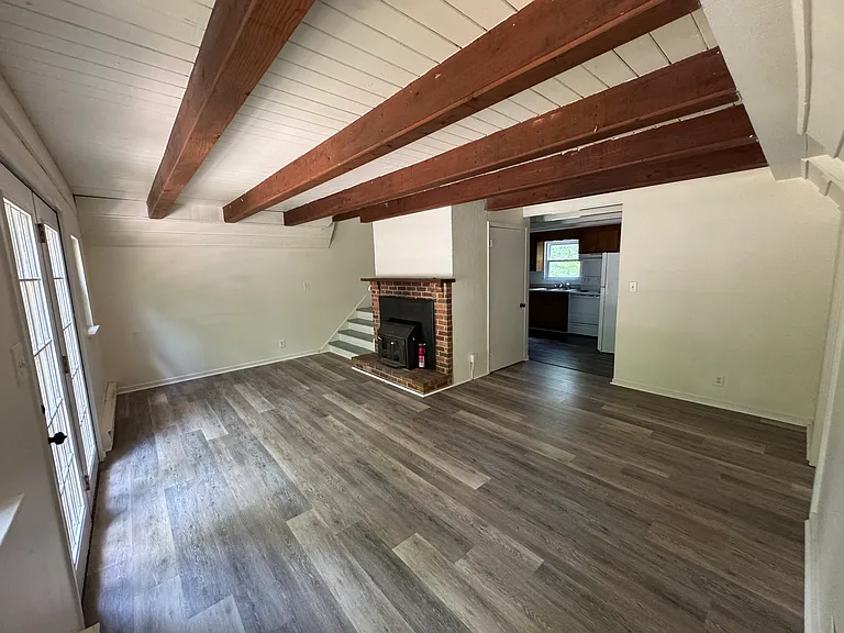 Living room with kitchen through the opening.