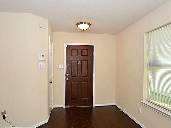 Entry with solid wood door and access to garage!