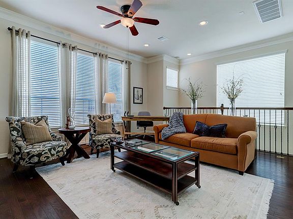 The second floor living area has great natural light and hardwood flooring.