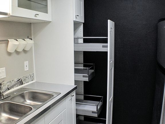 Pull-out tall cabinet feature to access hard to reach space
