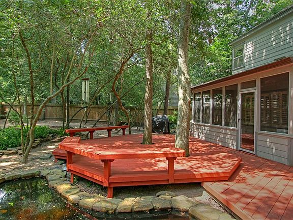 Screened in patio and deck with seating.