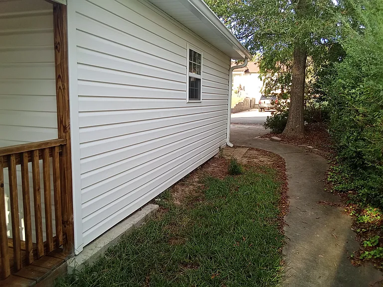 side walk on south of house leads to deck from front driveway