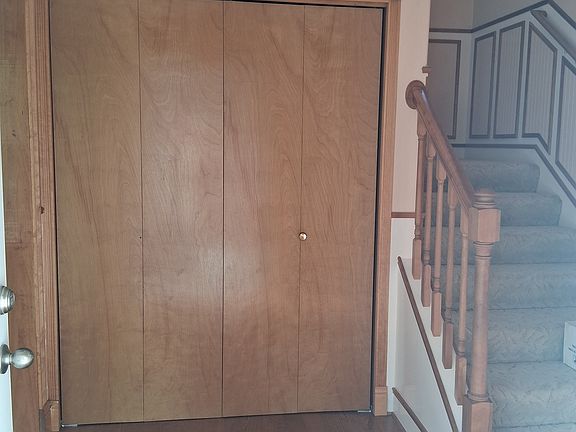 Front Entry, large coat closet, stairs to upstairs, living room through doorway to left