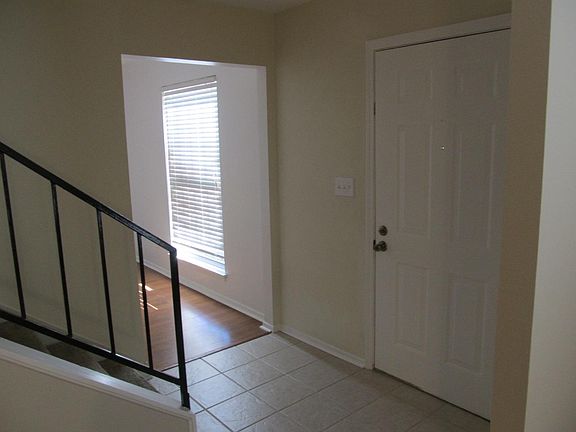 From inside living room showing front door and entrance to dining room.