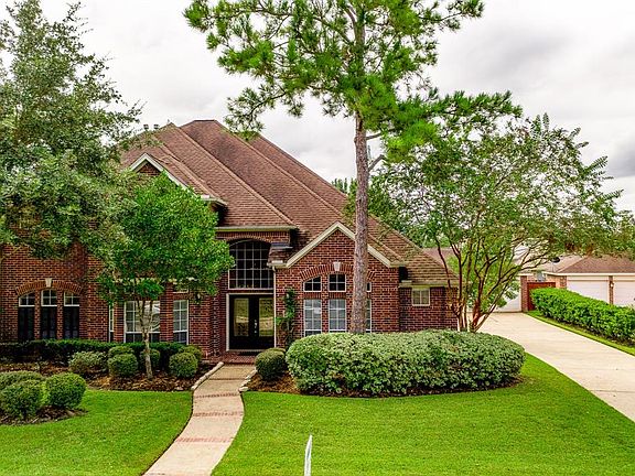 This classic brick style home features mature trees and double leaded glass door that offers great curb appeal!
