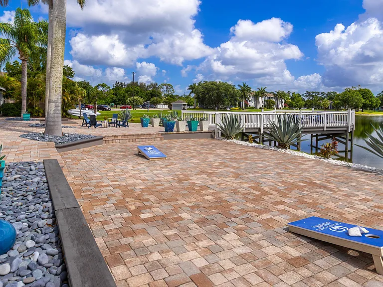 Enjoy a friendly game of cornhole on our scenic lakefront patio, surrounded by tropical landscaping and just steps from our relaxing outdoor seating.