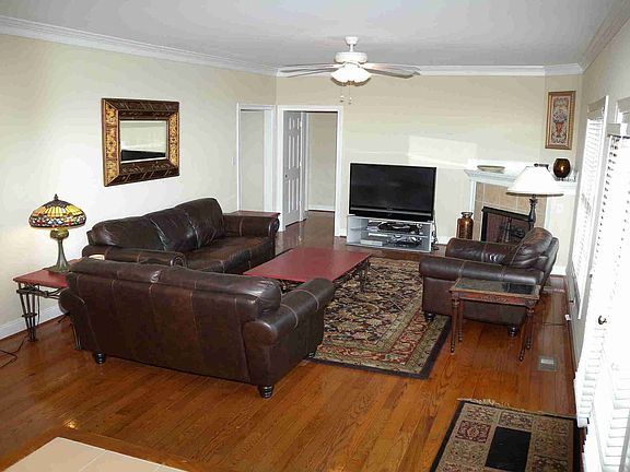 Inviting Family Room with hardwood floor and corner gas fireplace.
