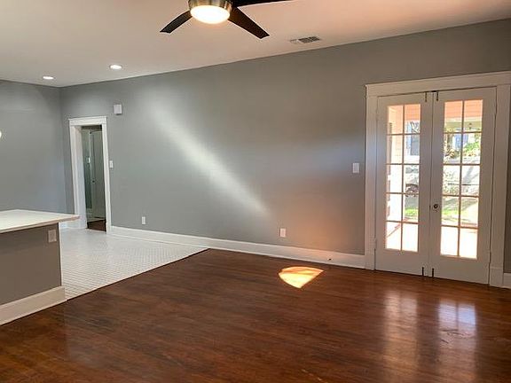 Open concept living between the living room and kitchen and double doors for direct access to large covered front porch