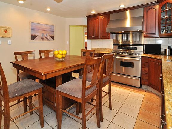 Eat in kitchen with granite countertops and stainless applia