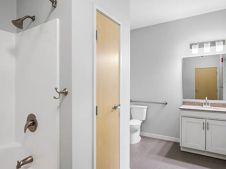Modern bathroom with elegant fixtures, spacious shower, and sleek vanity with ample storage. Modern bathroom with elegant fixtures, spacious shower, and sleek vanity with ample storage.