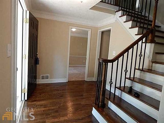 IRON SPINDLES LEADS YOU UPSTAIRS, AND THIS HOME HAS A LARGE HARDWOOD FOYER!