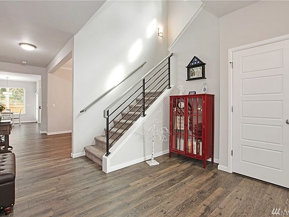 From the Front Entry. Beautiful laminate flooring downstairs, White painted Millwork and Doors. Entry closet/storage area and a downstairs bedroom just to my right.