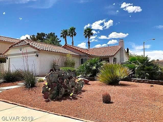 Front of house with professionally done desert landscape