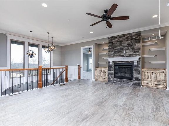 Stairs curve down to the left, with open area that looks down toward finished Family Room.