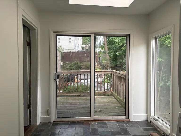 Sitting area as seen from kitchen. Seamlessly continues into a deck that overlooks the backyard. Huge skylight above sitting area.