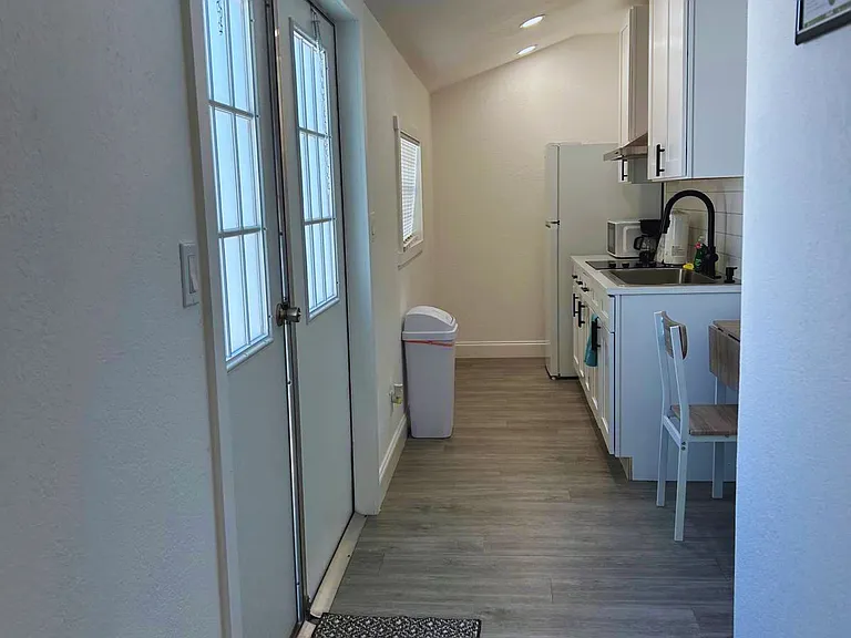 Cozy kitchen equipped with fridge and essential amenities.