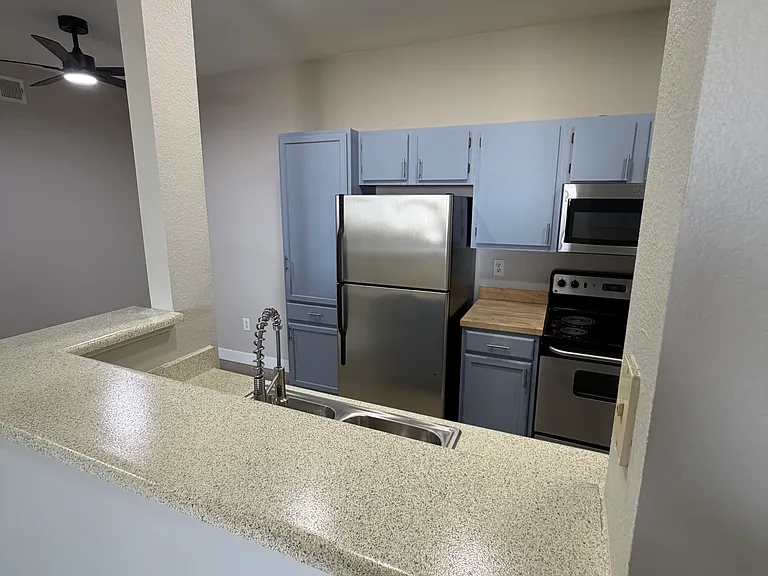 Kitchen with newly added pantry. Eating area off to left under new ceiling fan