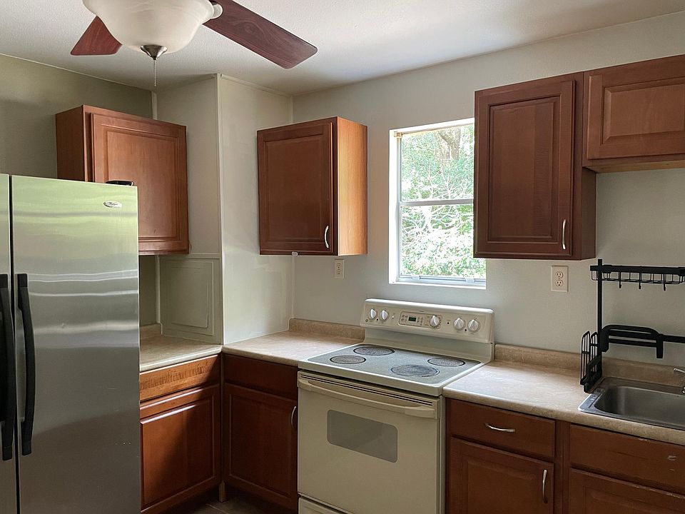 Full size fridge and stove. Nice natural light, and lots of cabinets
