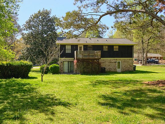 Backyard (will be completely fenced in) and rear view of home
