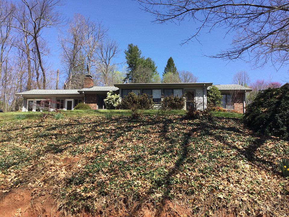 Home faces woods below and sunny slope behind on quiet neighborhood setting of 11 homes.
