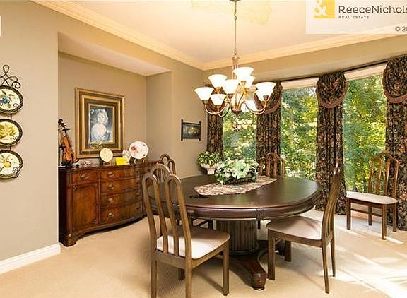 Large formal living room with yet another view of the beautiful wooded backyard.