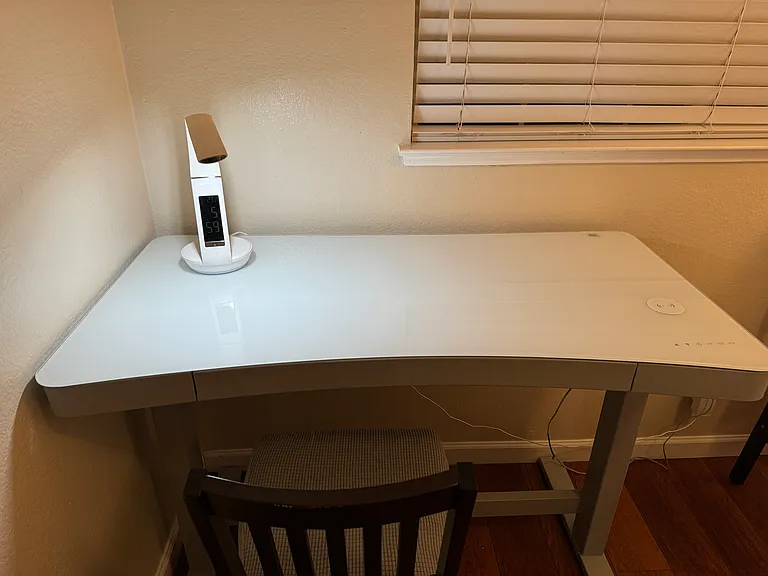 Height adjustable desk with Wireless phone charging.