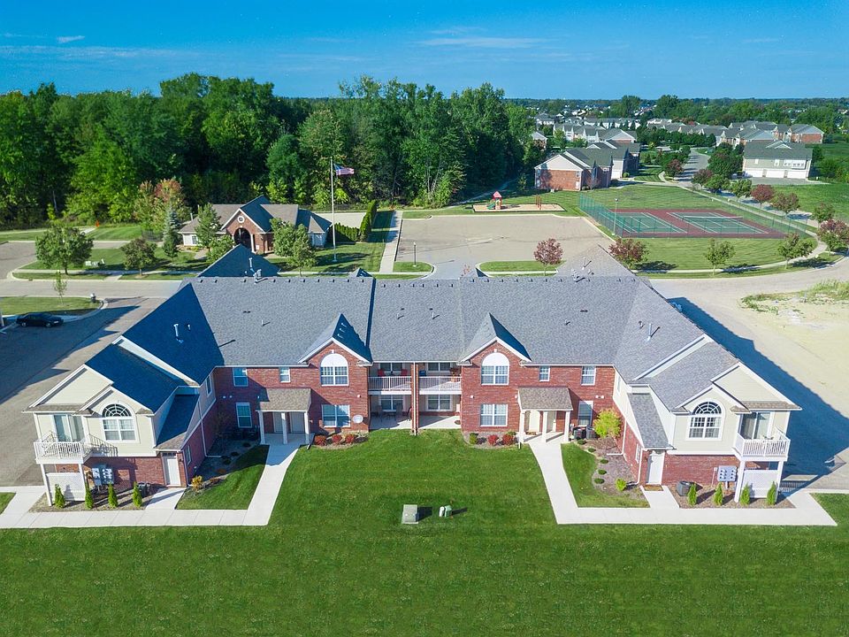 Aerial photo of tennis courts in distance plus club house with swimming pool