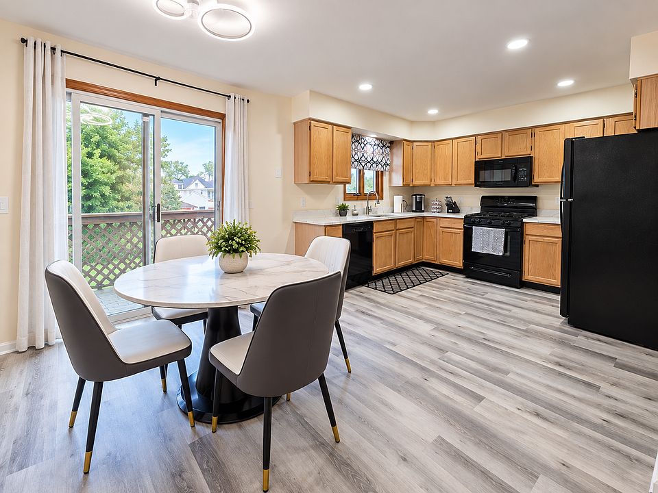 Bright, fully equipped kitchen with spacious dining area and abundant natural light