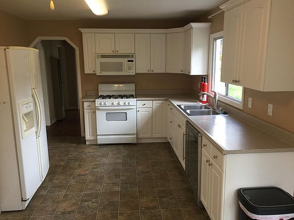 Redone kitchen looking from breakfast nook. The stove has a pancake pan gas burner too! GE fridge is included as of 6/2020