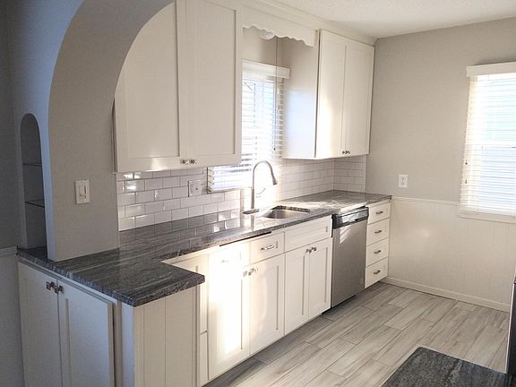 Recently updated kitchen: white, shaker cabinet fronts, granite countertops, stainless appliances, dishwasher, and garbage disposal.