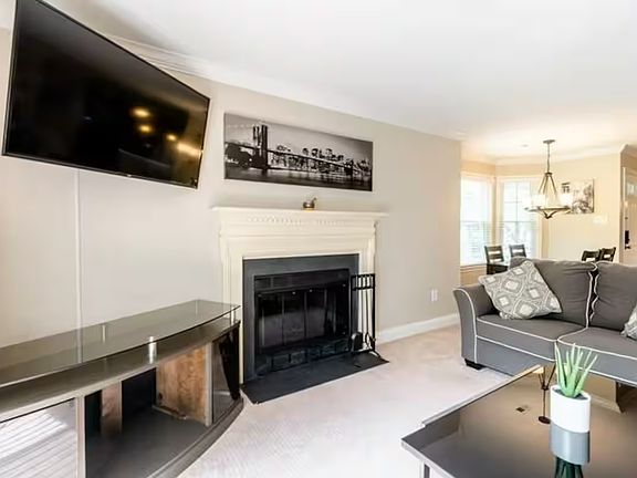 Living room angle from sliding door facing the fireplace + 50" Smart TV.