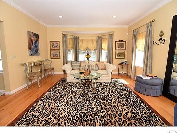 Sun filled living room.  Custom windows, crown molding and recessed lighting accents this spacious room.