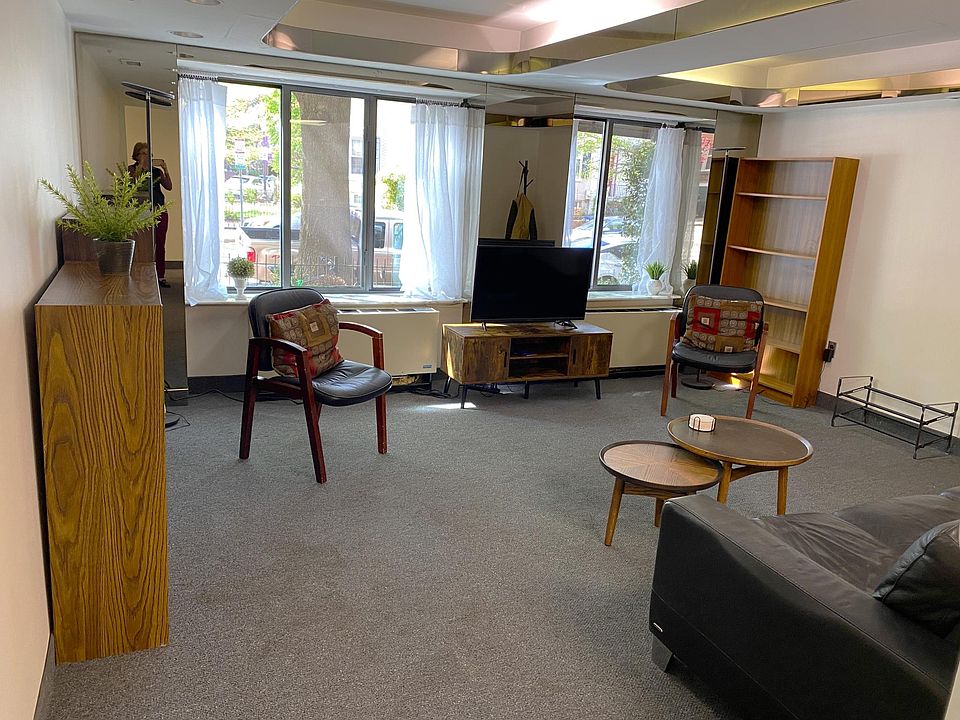 Large livingroom with new large windows nad seating. View towards I St.