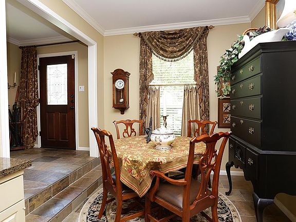 View of breakfast room adjacent to entry. Pella windows throughout ('10). Custom drapes all remain.