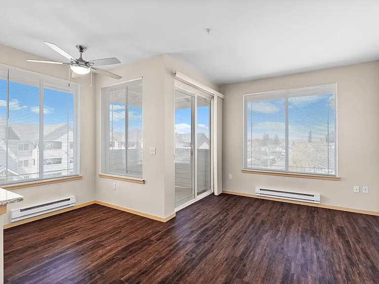 Soak in the sunlight! This spacious living area boasts large windows, a ceiling fan for comfort, and access to your own private balcony. Soak in the sunlight! This spacious living area boasts large windows, a ceiling fan for comfort, and access to your ow