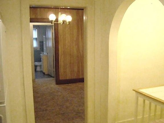 View from kitchen to bathroom through dining