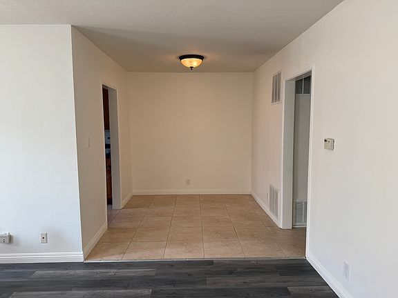 Dining area, with kitchen entrance to the left and entrance to the hallway to the right leading to bedroom and bathroom
