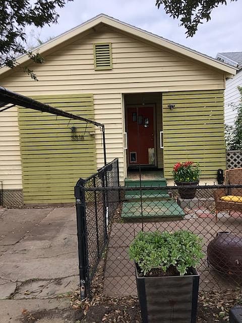 FRONT OF HOUSE, AND PORCH, SMALL FENCED YARD.