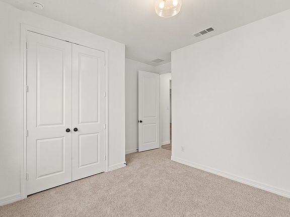 An additional view of the second bedroom and closet.