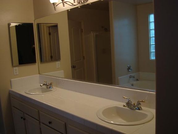 Master bath with double sinks and separate tub and shower.