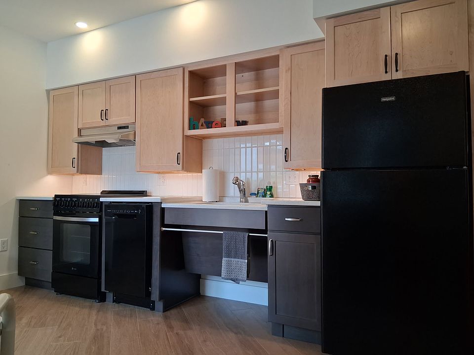 The kitchen has plenty of countertop and storage space, includes a dishwasher