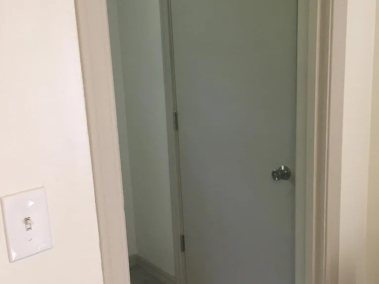 Indoor utility room with exterior access door to parking