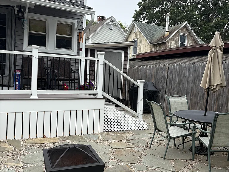 fire pit, patio, patio table, chairs, umbrella, gas grill