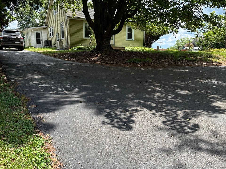 house has large front yard, and additional space for three cars off the driveway