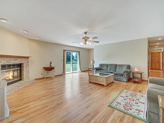 Stairs to the unfinished attic reside around the corner to the right of the patio door. Attic is expansive with 16 x 52 feet of storage area, plywood floor, and 2 exhaust fans.