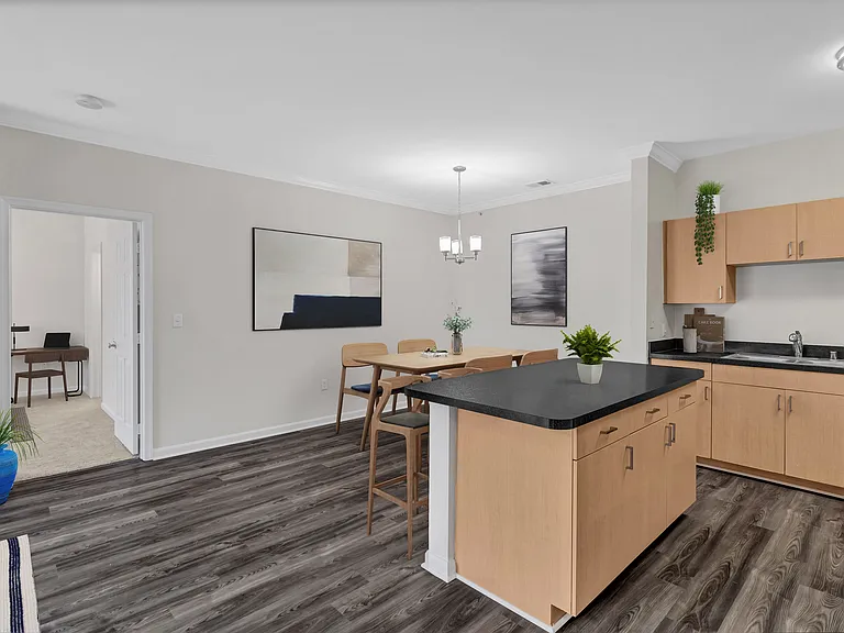 A kitchen with wooden cabinets and a black countertop.